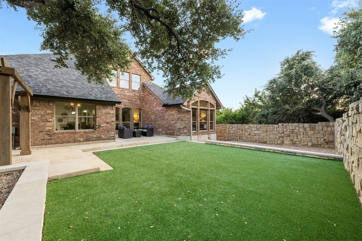 166 Briarpatch Court Austin, TX 78737 - Photo 33 of 40 a front view of a house with a garden and plants