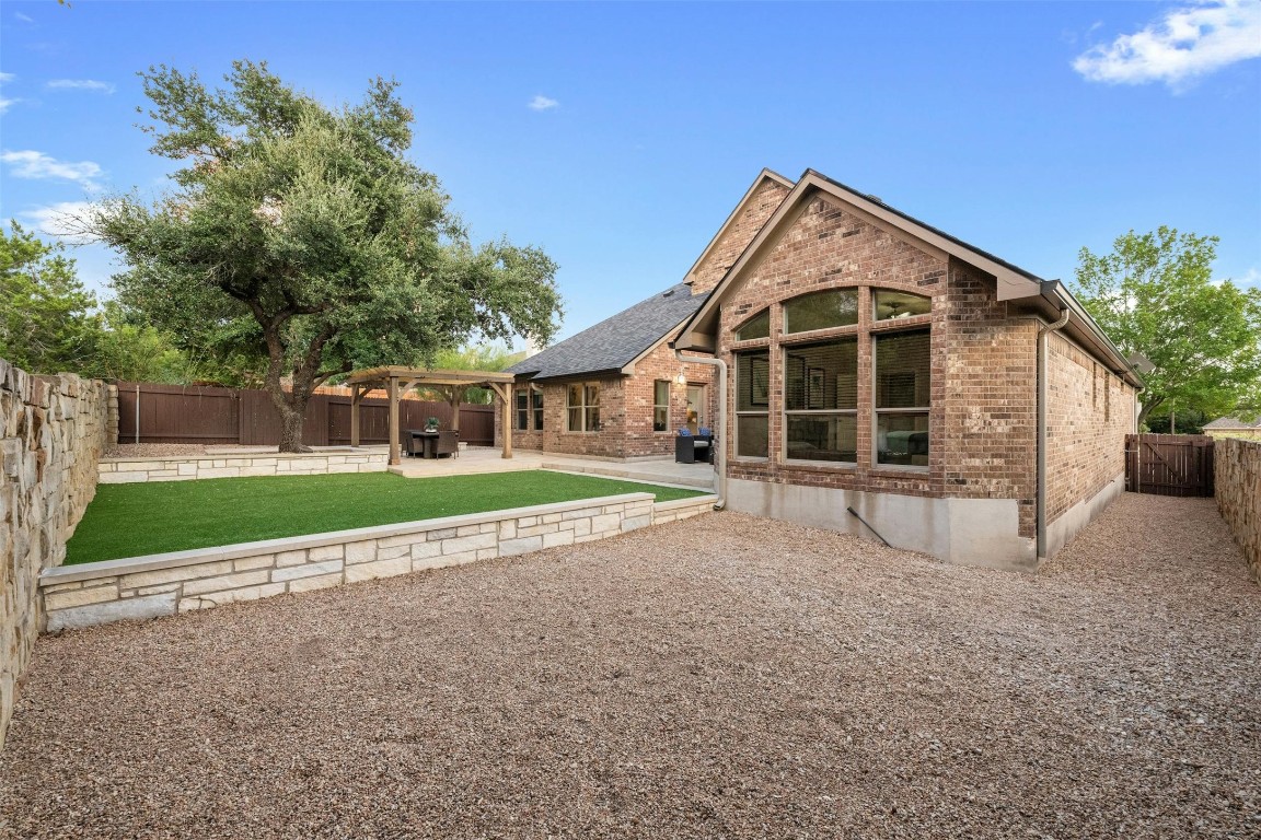 166 Briarpatch Court Austin, TX 78737 - Photo 35 of 40 a view of house with a yard and large tree