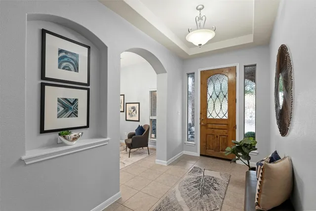 a living room with furniture piano and a window