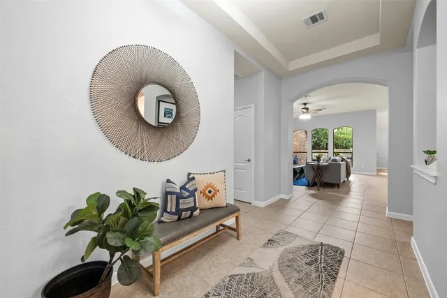 a living room with furniture and a potted plant