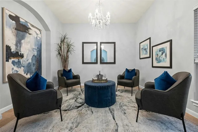 a living room with furniture and a chandelier