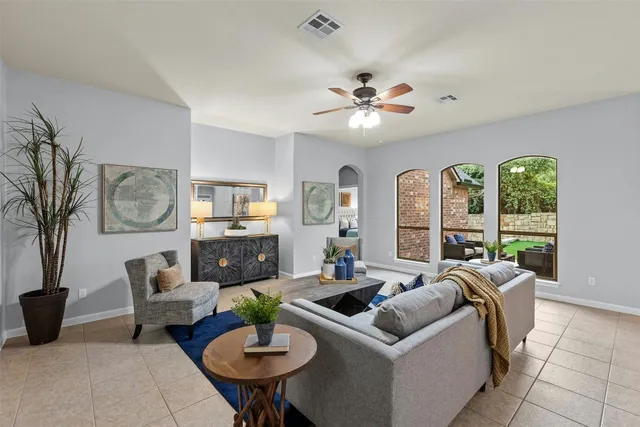 a living room with furniture a fireplace and a table