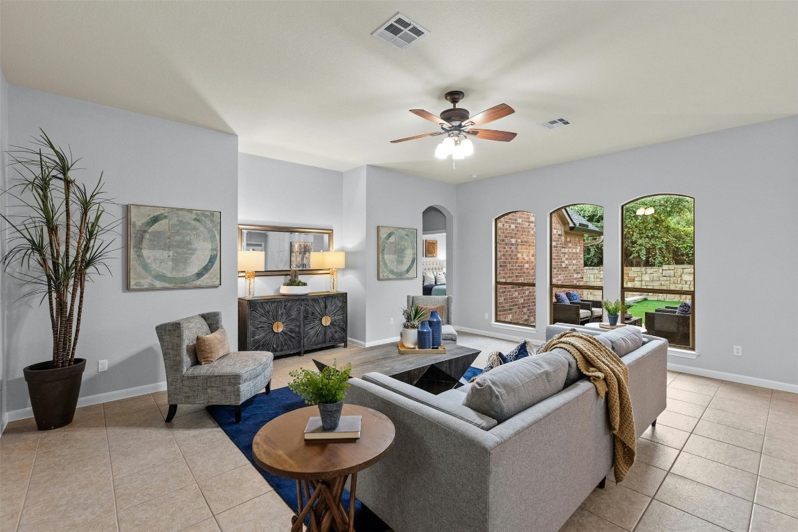 166 Briarpatch Court Austin, TX 78737 - Photo 7 of 40 a living room with furniture a fireplace and a table
