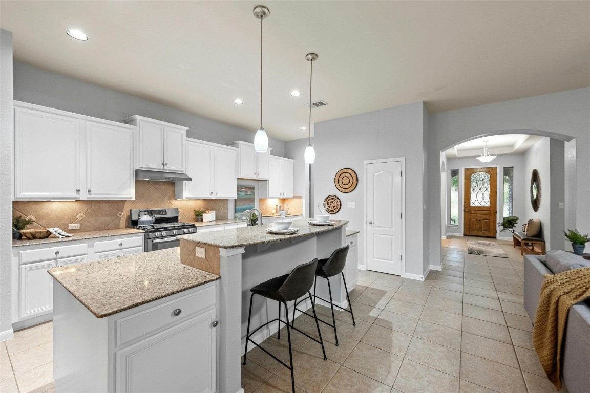166 Briarpatch Court Austin, TX 78737 - Photo 40 of 40 a kitchen with stainless steel appliances granite countertop a sink a stove a refrigerator and cabinets