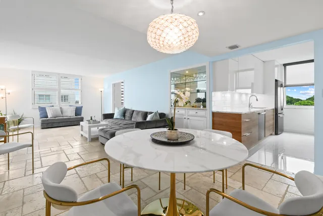 a view of a dining room with furniture and chandelier