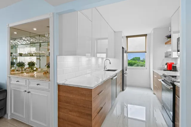 a kitchen with granite countertop a stove and a sink