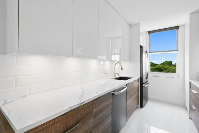 a kitchen with a sink cabinets and window