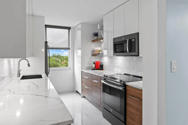 a kitchen with stainless steel appliances granite countertop a stove and a microwave
