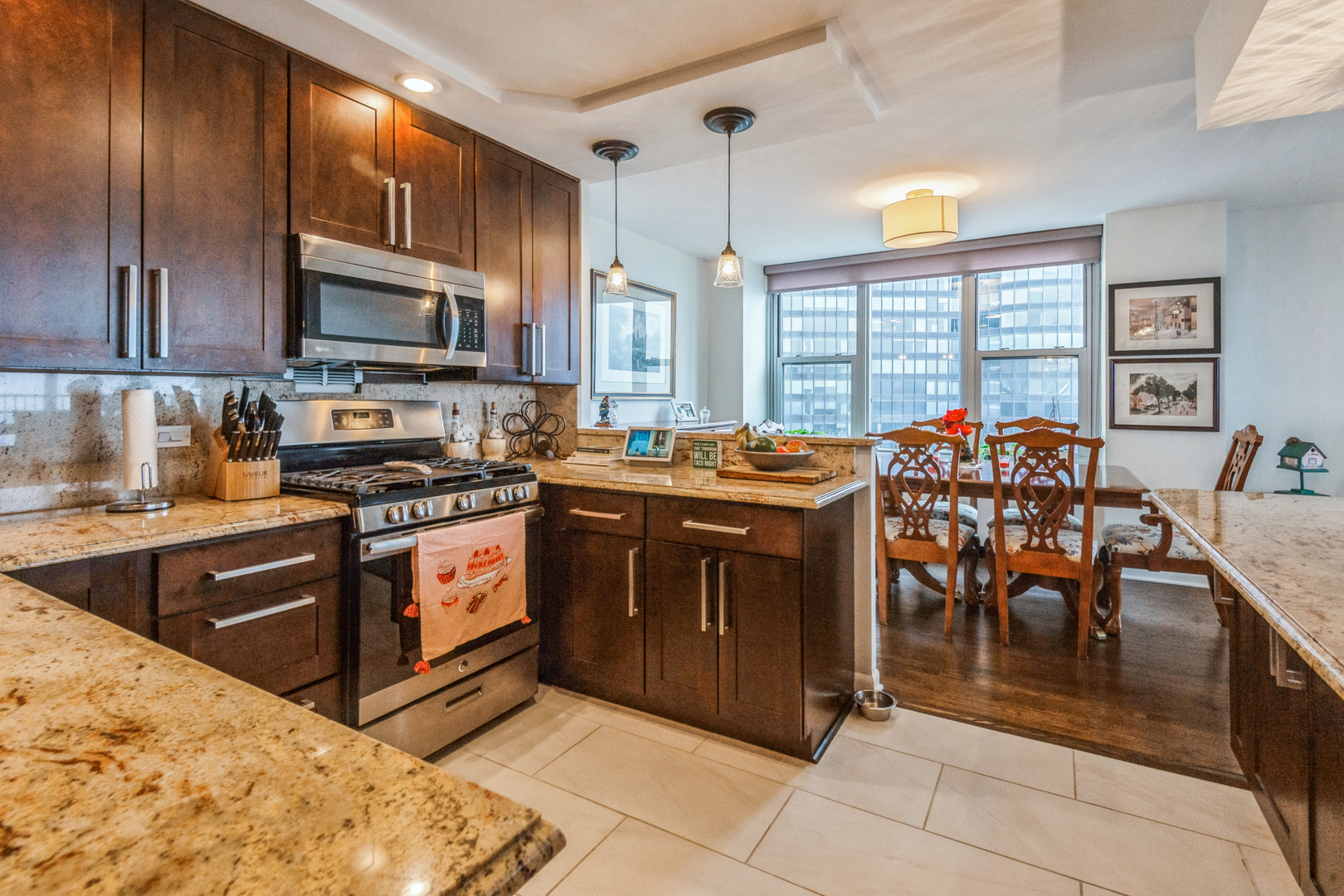 400 East Randolph Street, Unit 3209 Chicago, IL 60601 - Photo 9 of 59 a kitchen with stainless steel appliances granite countertop a stove a sink dishwasher a microwave oven and a refrigerator