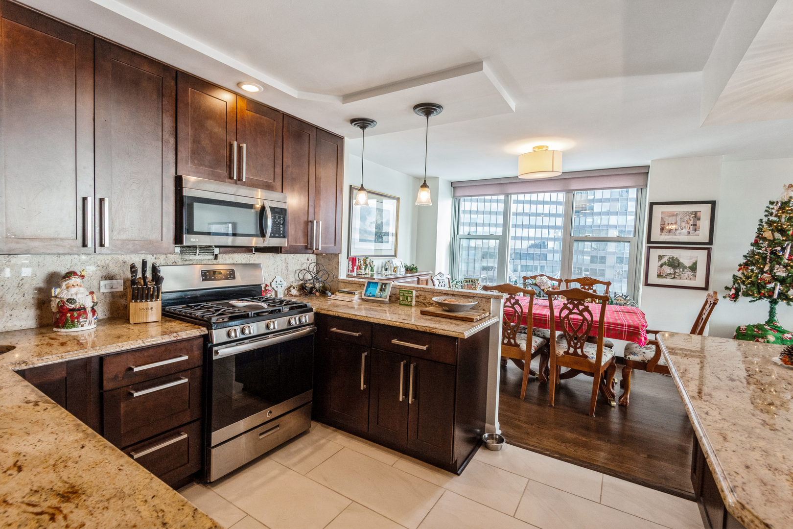 400 East Randolph Street, Unit 3209 Chicago, IL 60601 - Photo 26 of 59 a kitchen with stainless steel appliances granite countertop a stove a sink dishwasher and a microwave oven with cabinets