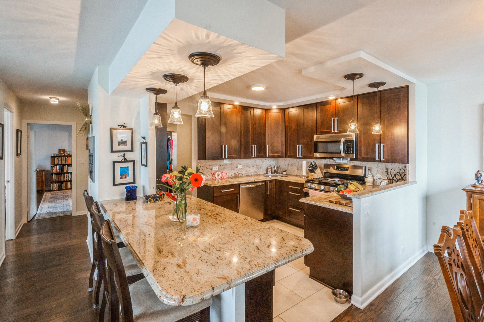 400 East Randolph Street, Unit 3209 Chicago, IL 60601 - Photo 2 of 59 a kitchen with stainless steel appliances dining table and chairs