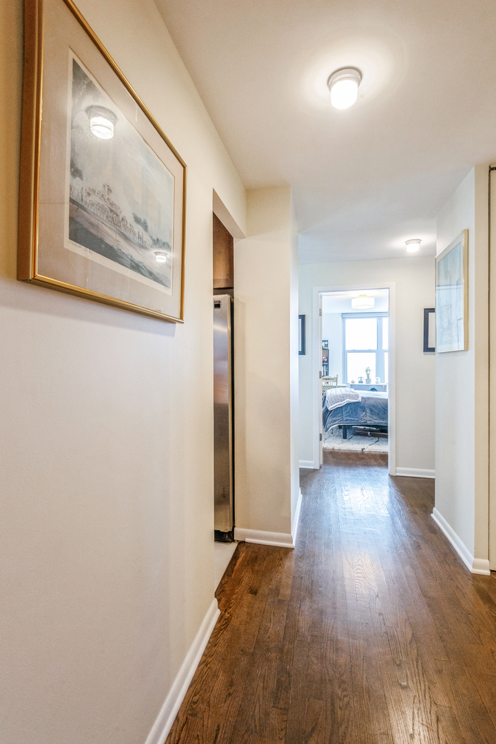 400 East Randolph Street, Unit 3209 Chicago, IL 60601 - Photo 3 of 59 a view of a hallway with wooden floor and a bathroom