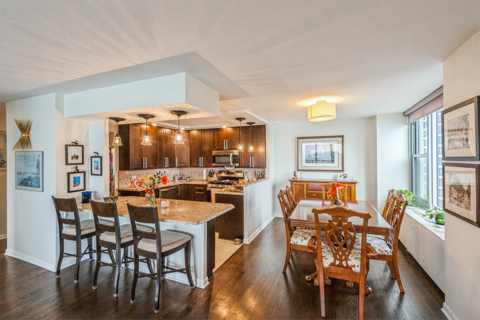 400 East Randolph Street, Unit 3209 Chicago, IL 60601 - Photo 8 of 59 a view of a dining room with furniture and wooden floor
