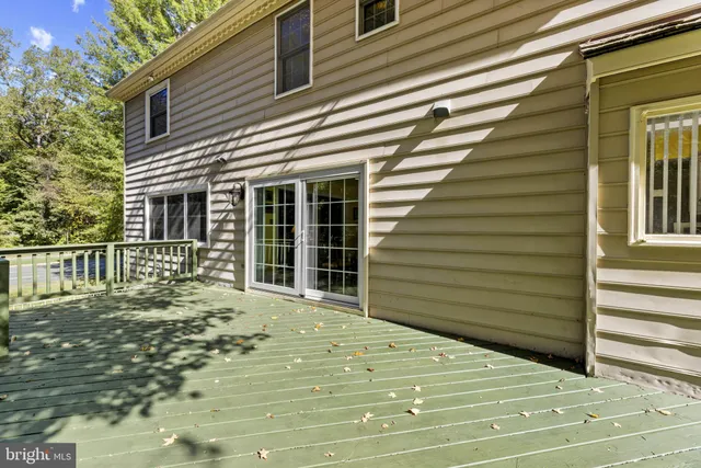 a view of a house with a large window and wooden fence