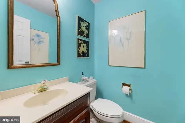 a bathroom with a sink mirror and toilet