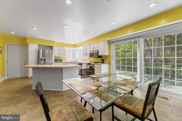 a view of a dining room with furniture and a kitchen