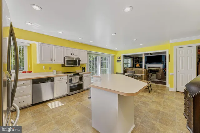 a kitchen with white cabinets and a sink
