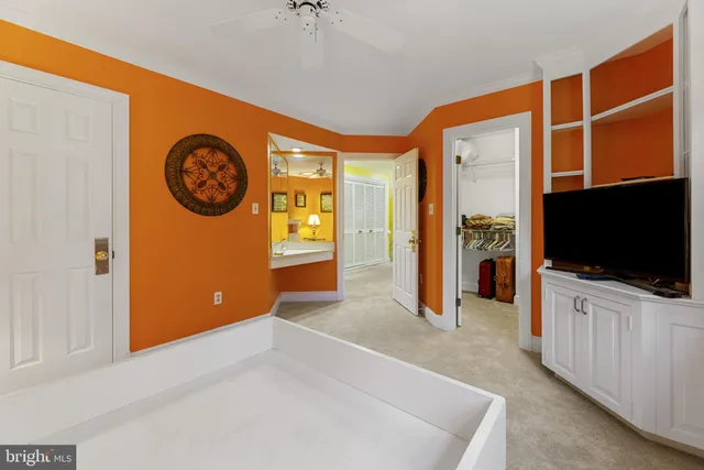 a bathroom with a granite countertop toilet sink and mirror