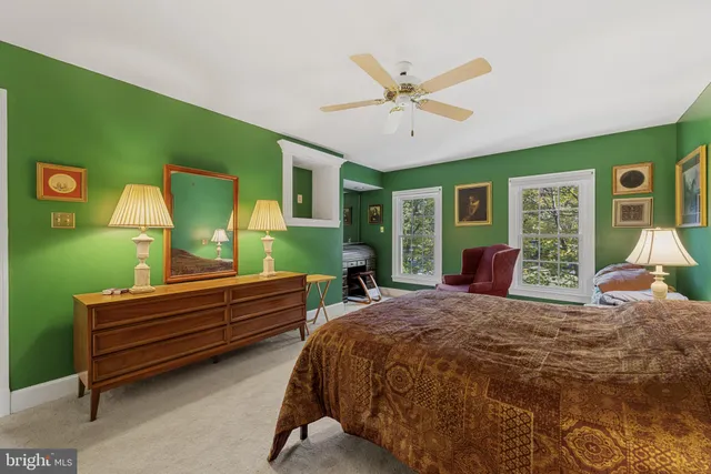 a bedroom with a bed and windows