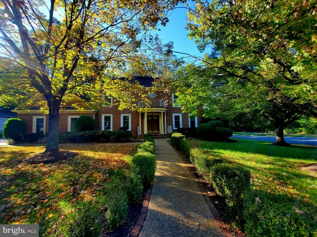 a front view of a house with a yard table and chairs