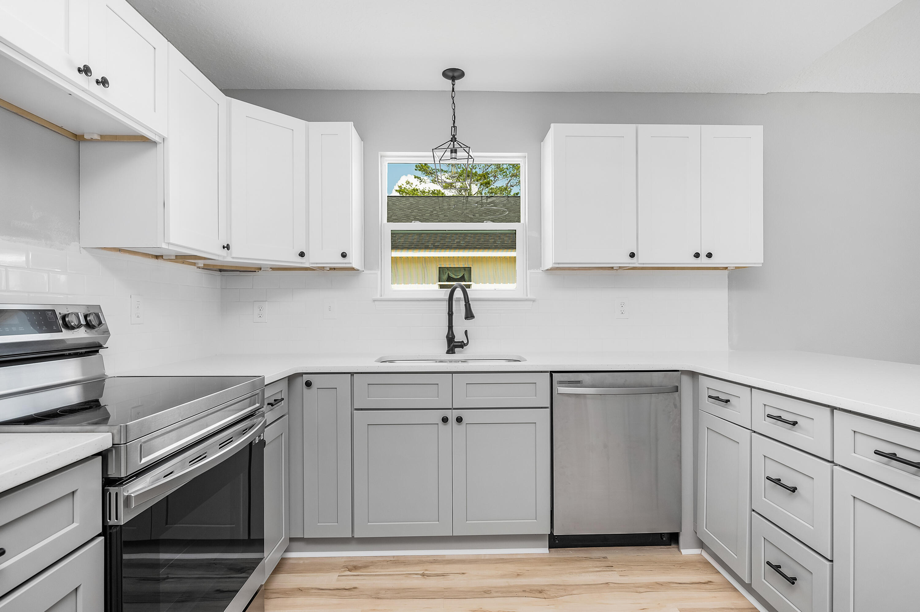 4622 Dove Way Crestview, FL 32539 - Photo 11 of 39 a kitchen with white cabinets appliances and sink