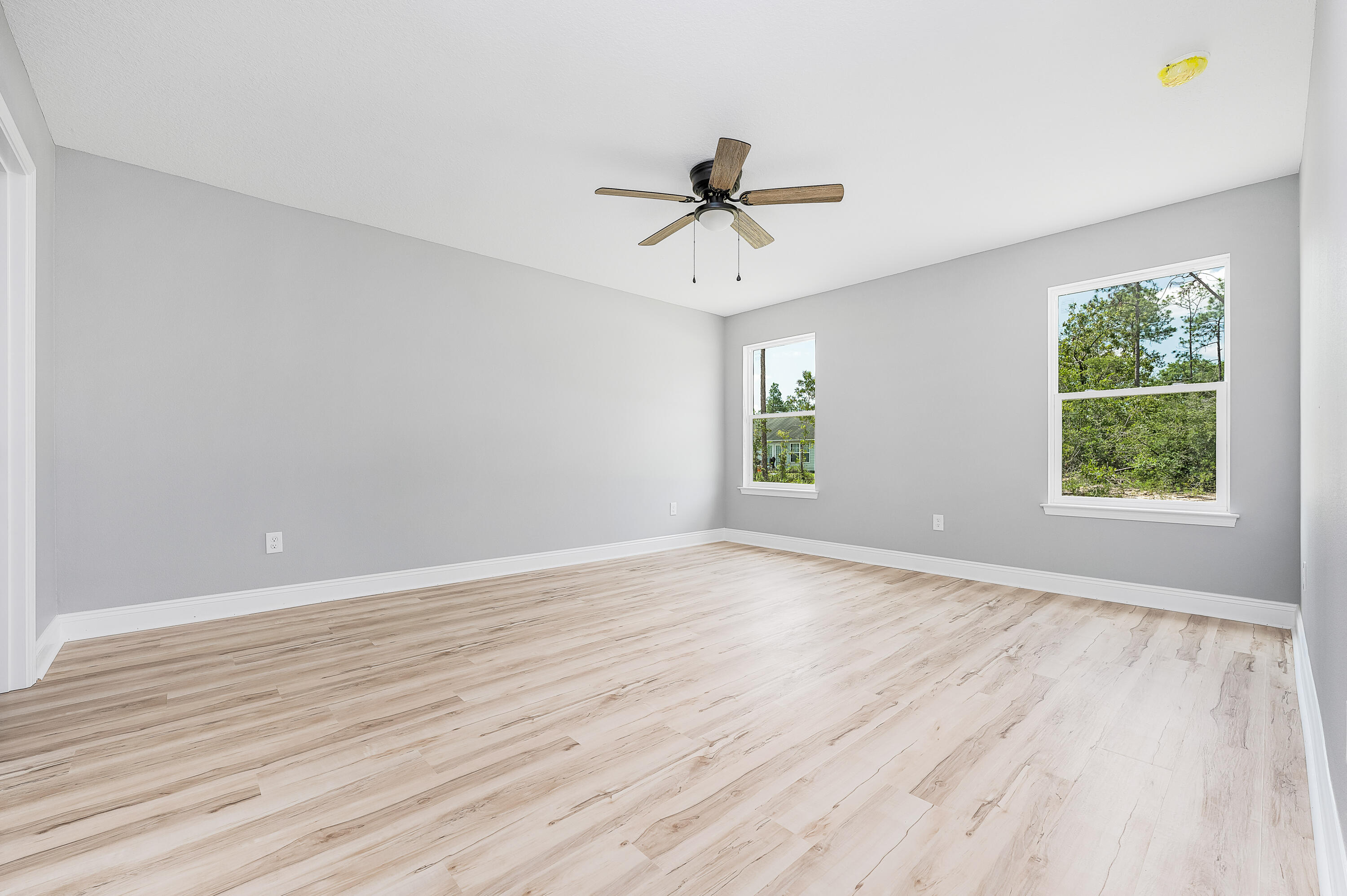 4622 Dove Way Crestview, FL 32539 - Photo 21 of 39 wooden floor in an empty room with a window