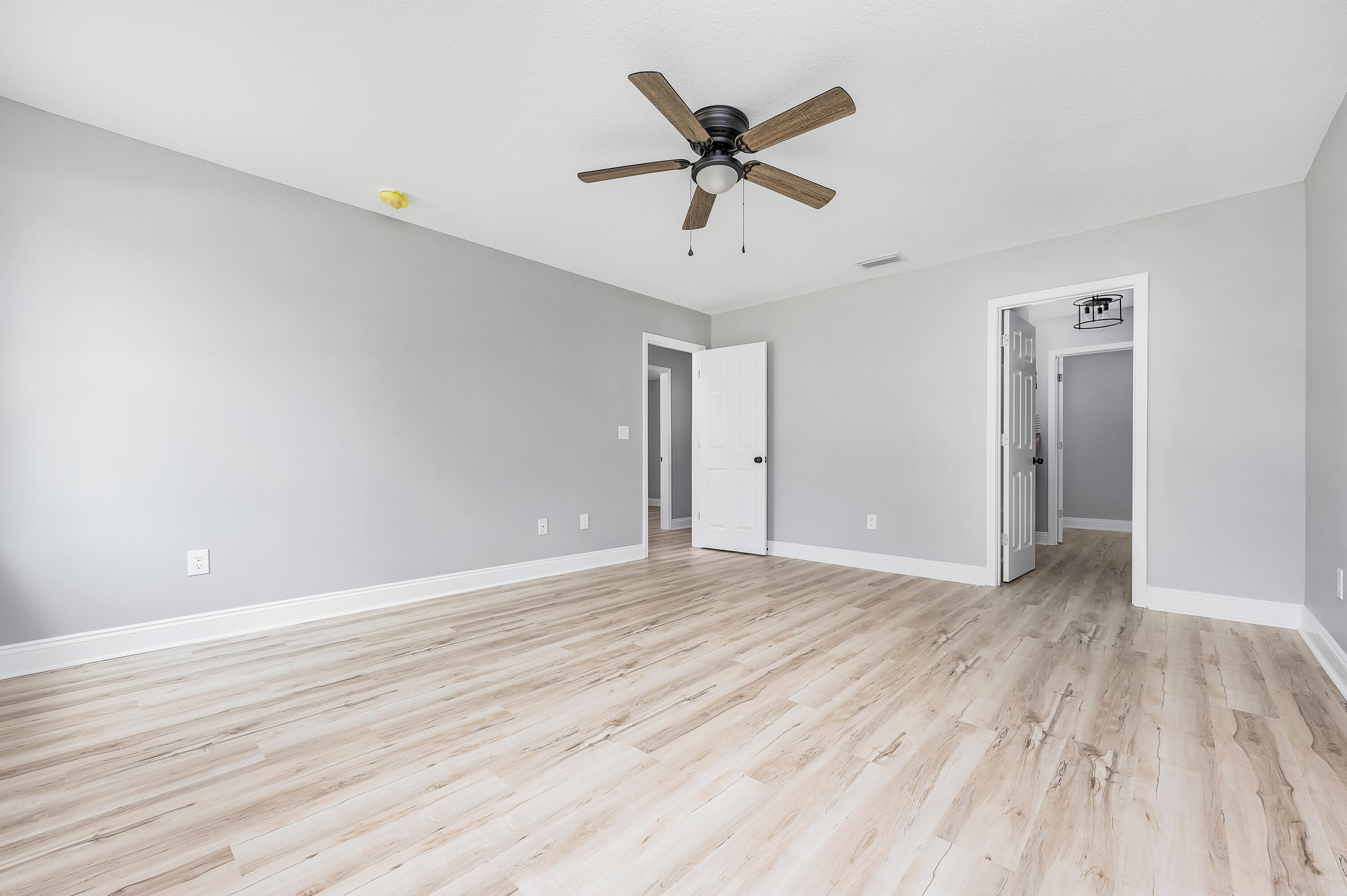 4622 Dove Way Crestview, FL 32539 - Photo 23 of 39 an empty room with wooden floor and windows