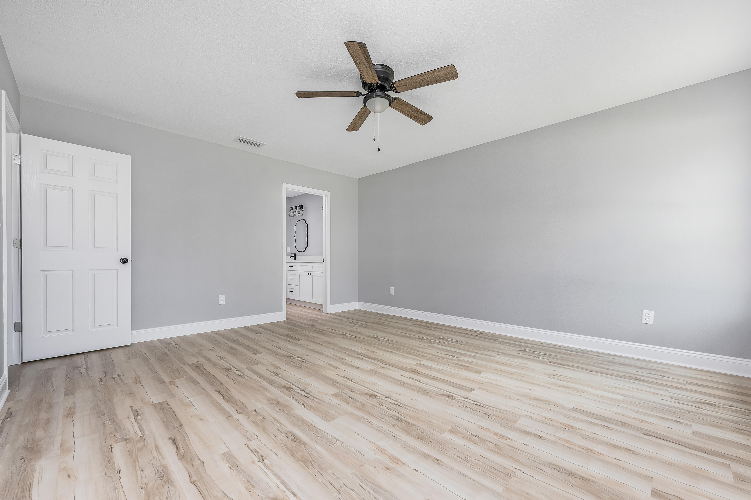 4622 Dove Way Crestview, FL 32539 - Photo 24 of 39 a view of room with wooden floor and ceiling fan