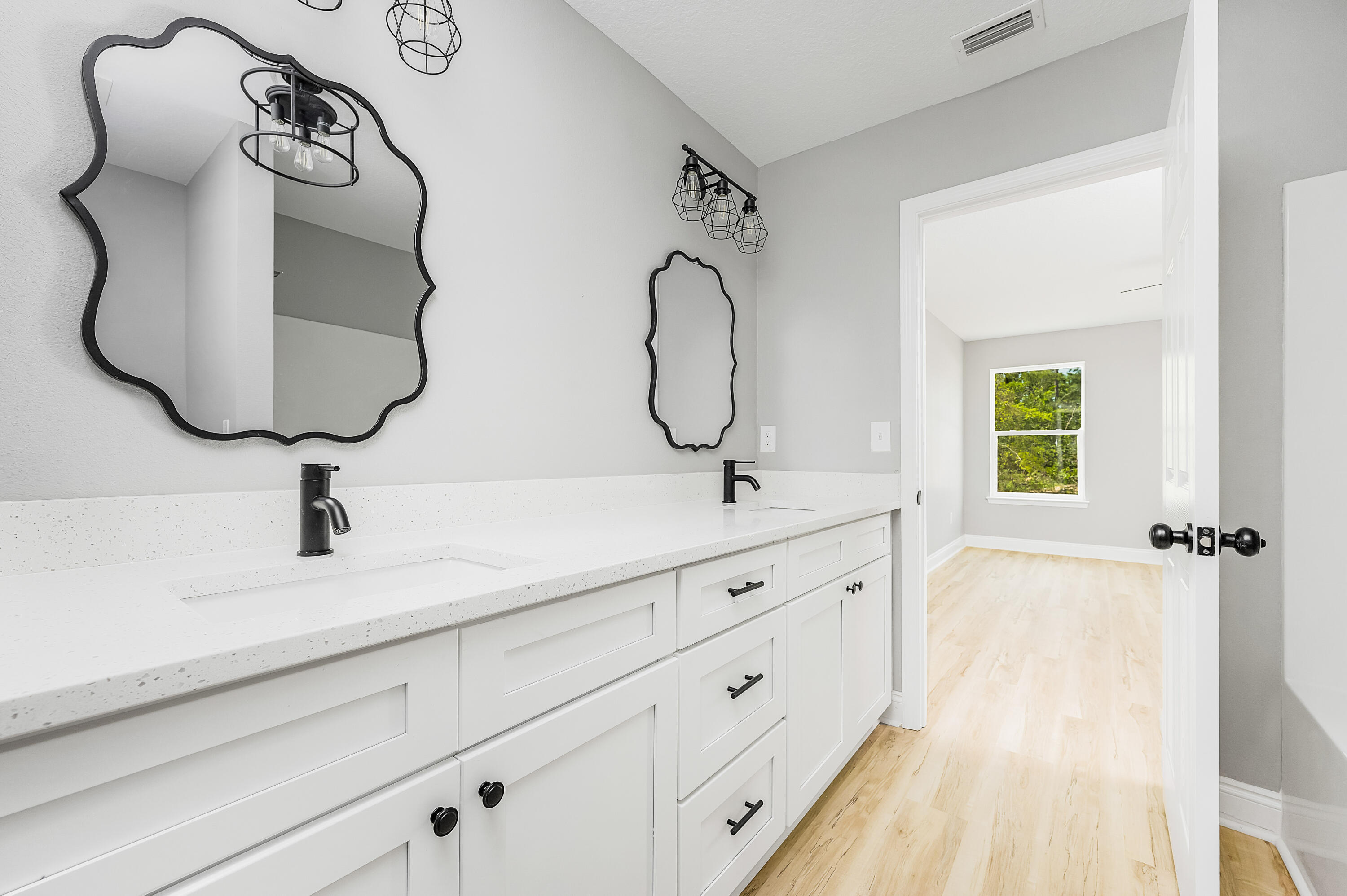 4622 Dove Way Crestview, FL 32539 - Photo 26 of 39 a bathroom with double vanity sink and a mirror