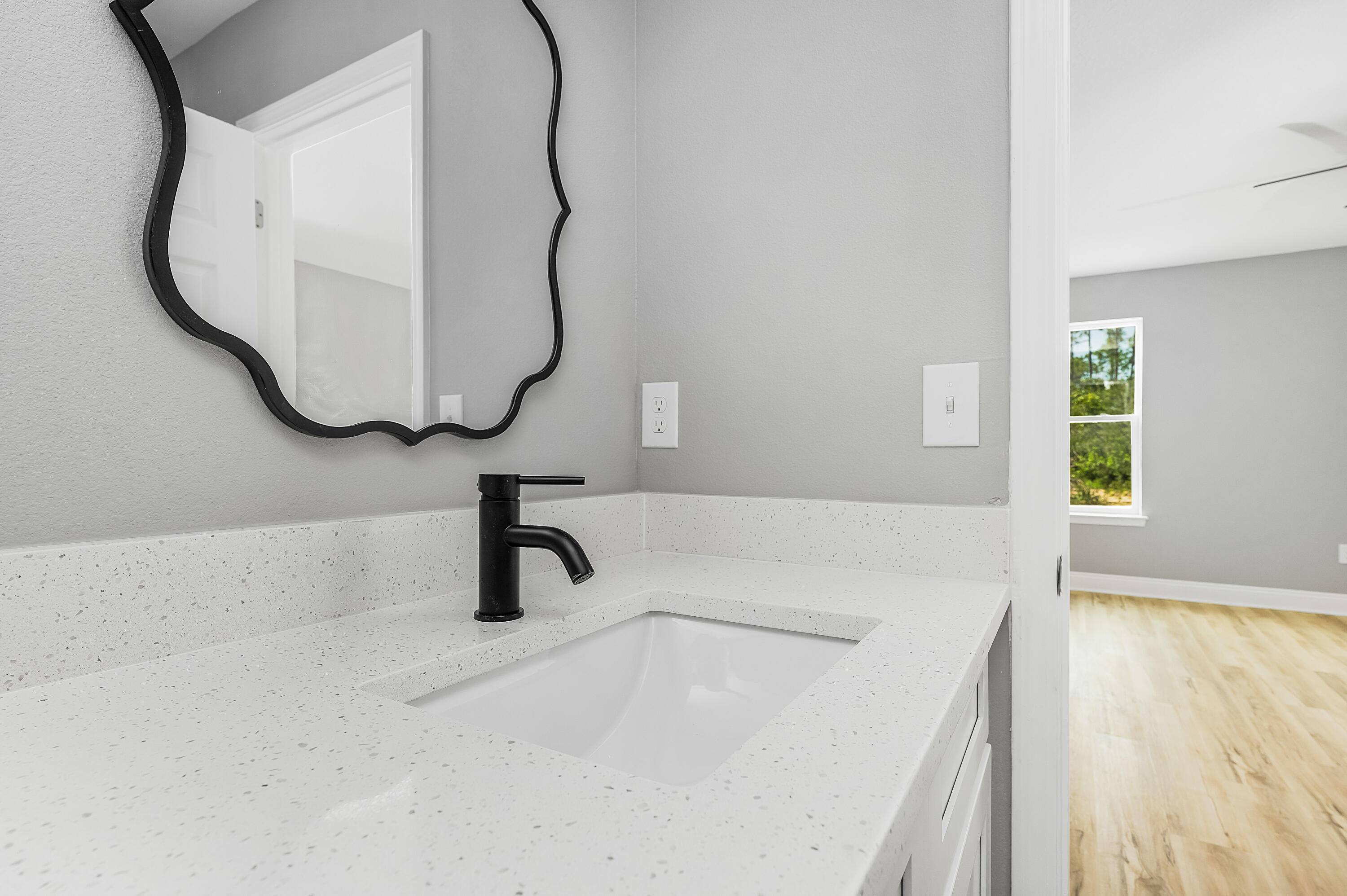 4622 Dove Way Crestview, FL 32539 - Photo 30 of 39 a bathroom with a sink and a mirror