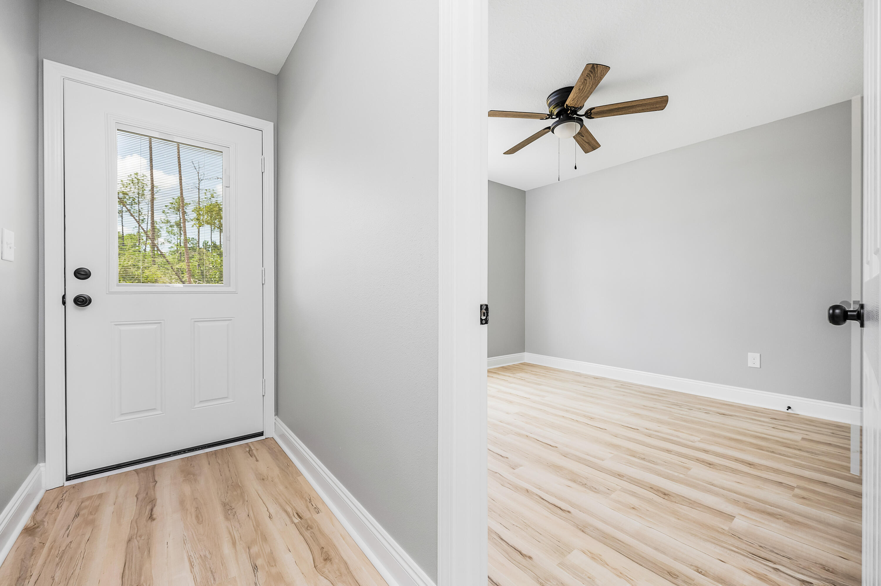 4622 Dove Way Crestview, FL 32539 - Photo 31 of 39 a view of empty room with wooden floor and ceiling fan