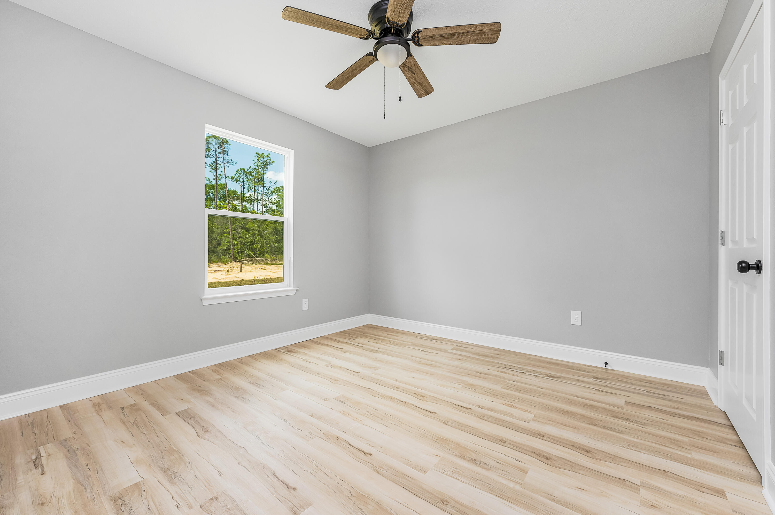 4622 Dove Way Crestview, FL 32539 - Photo 32 of 39 wooden floor in an empty room with a window