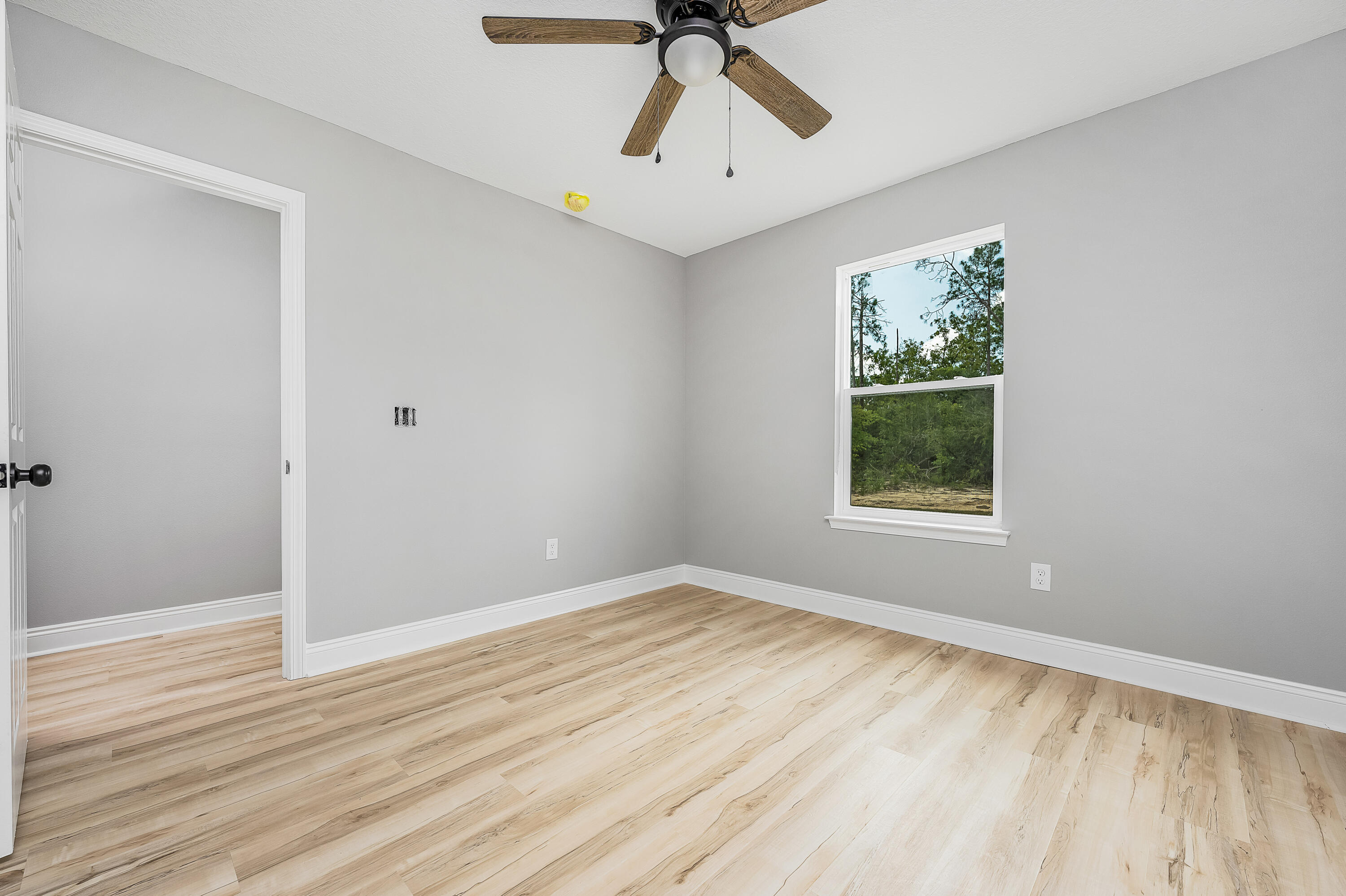 4622 Dove Way Crestview, FL 32539 - Photo 35 of 39 wooden floor in an empty room with a window