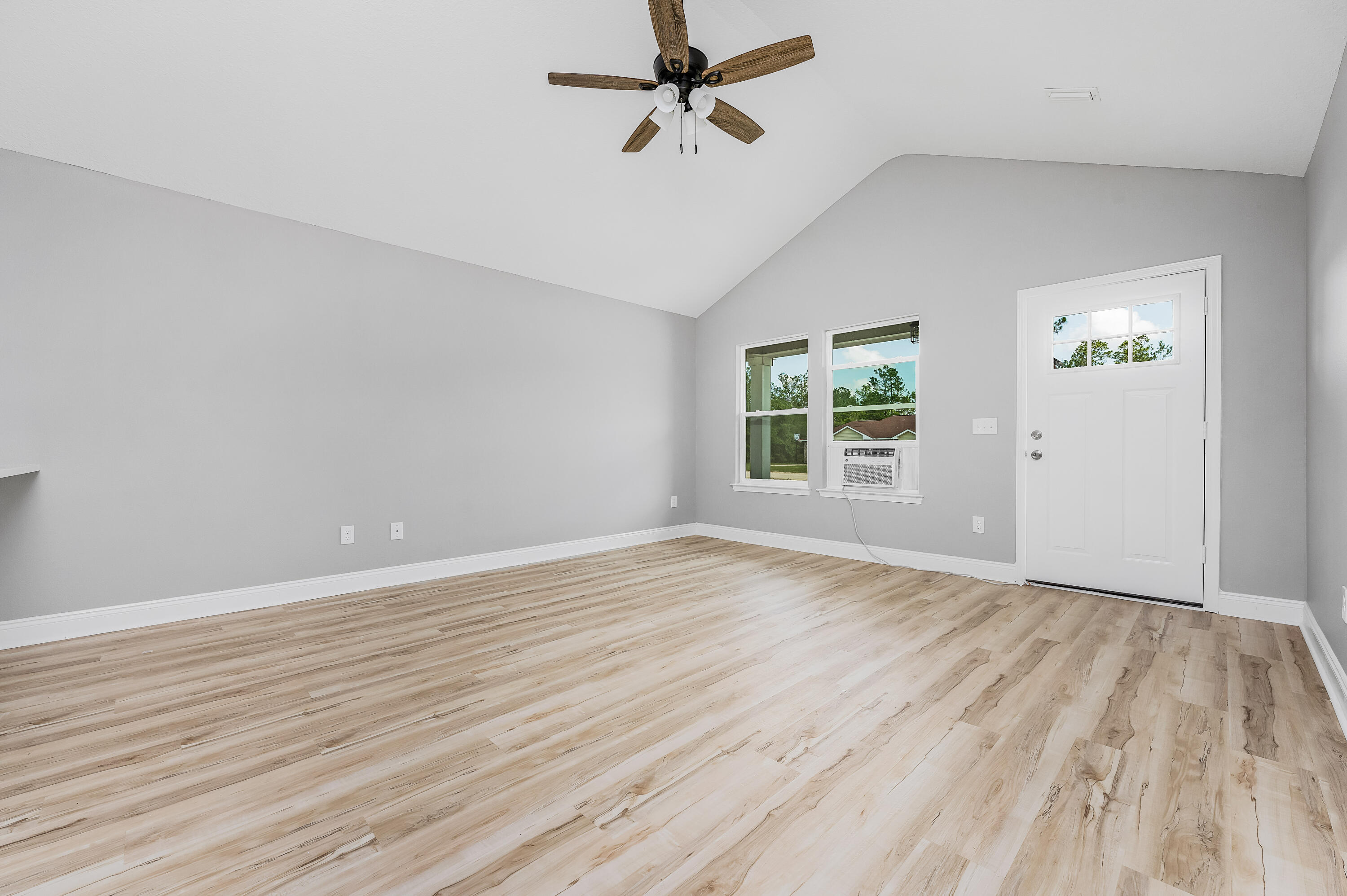 4622 Dove Way Crestview, FL 32539 - Photo 6 of 39 wooden floor in an empty room with a window