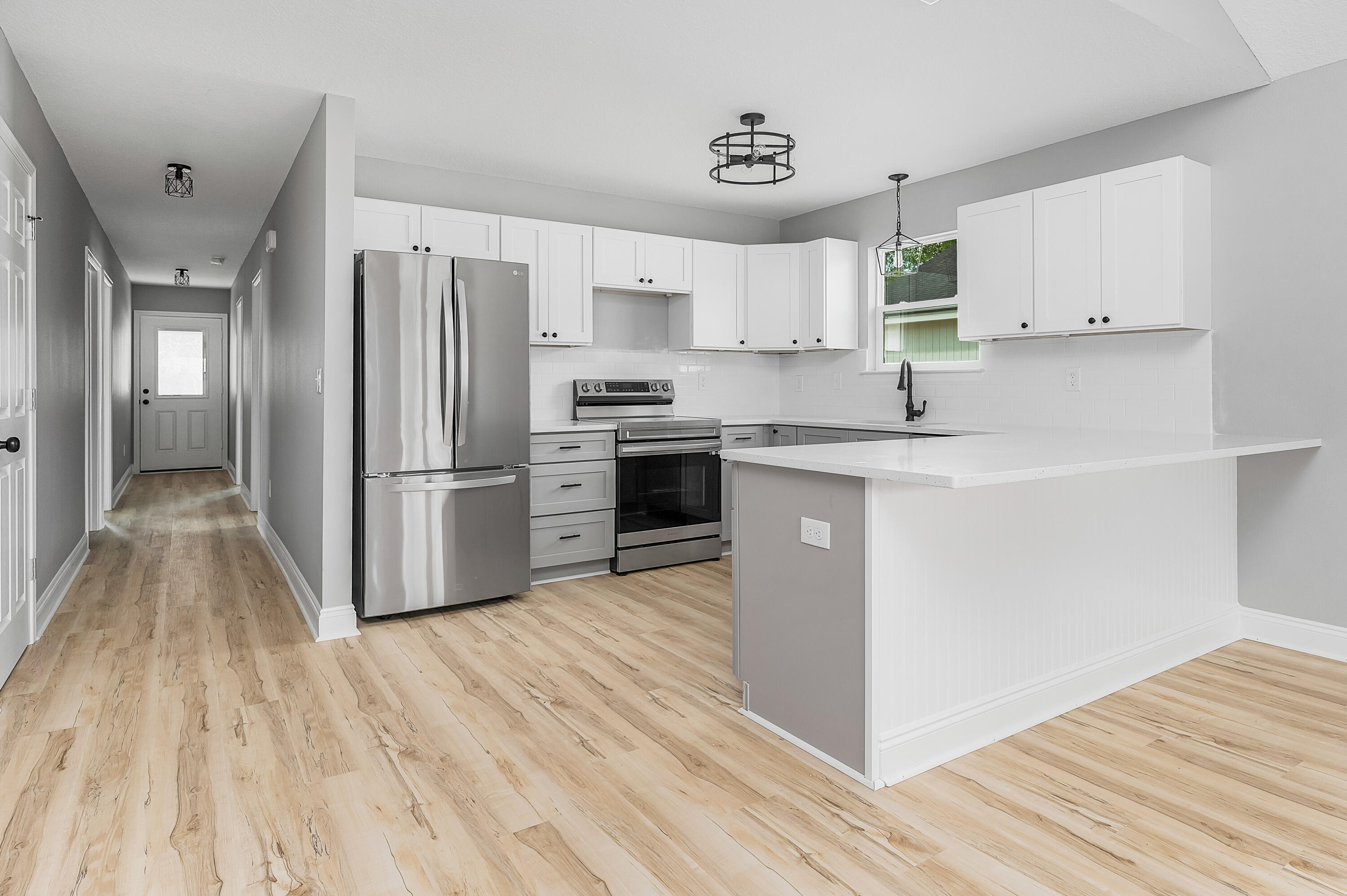 4622 Dove Way Crestview, FL 32539 - Photo 9 of 39 a kitchen with wooden floors and white appliances