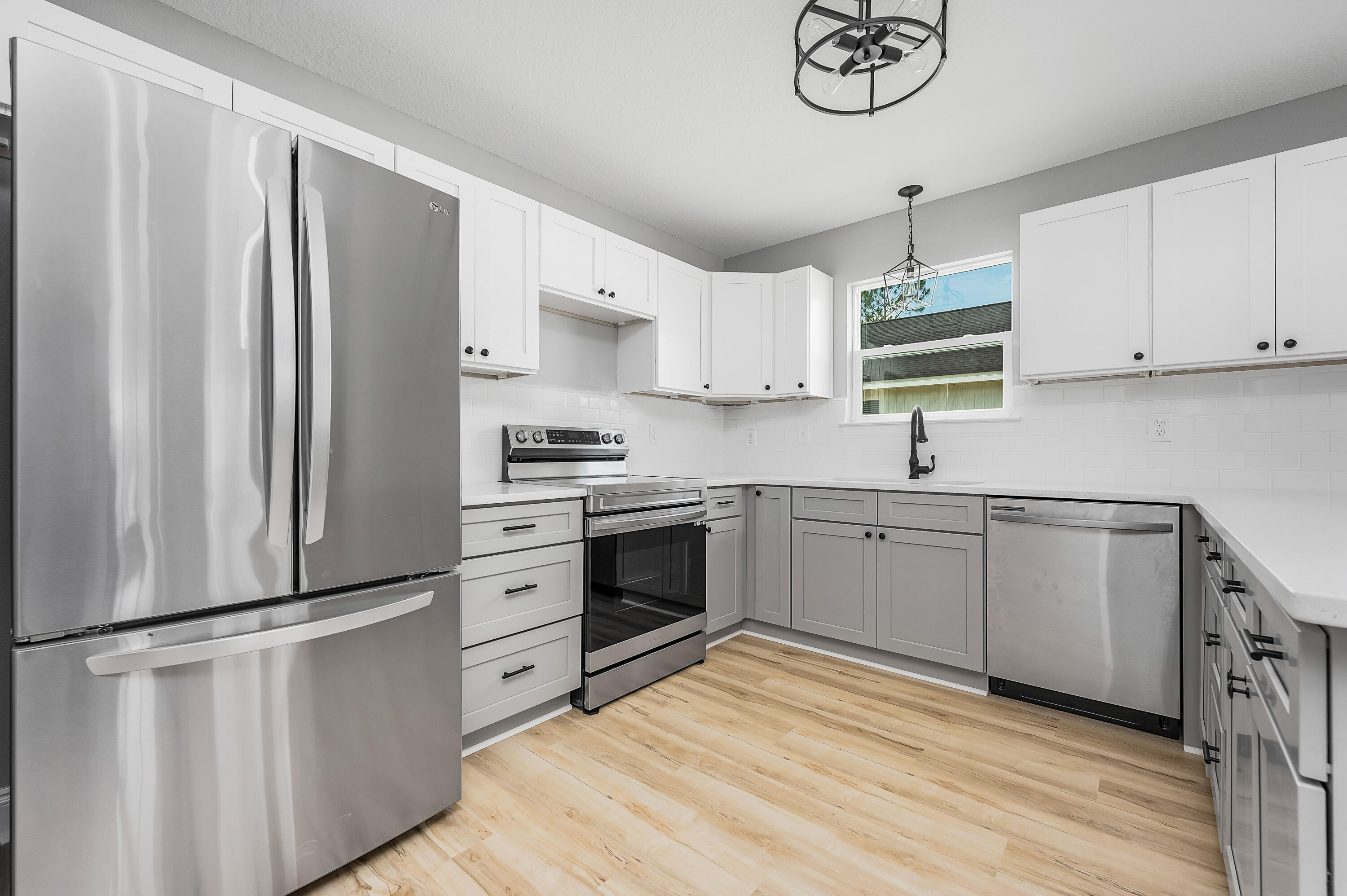 4622 Dove Way Crestview, FL 32539 - Photo 10 of 39 a kitchen with stainless steel appliances a refrigerator sink and cabinets