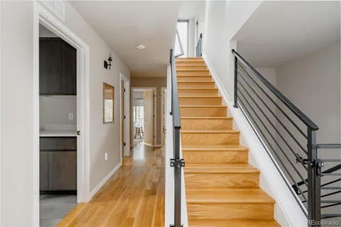 a view of a hallway with wooden floor and entryway