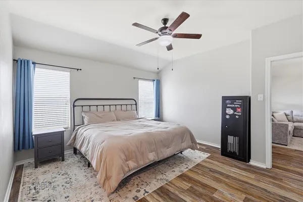 a bedroom with a large bed and a large window