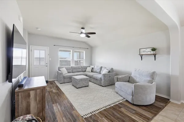 a living room with furniture and wooden floor