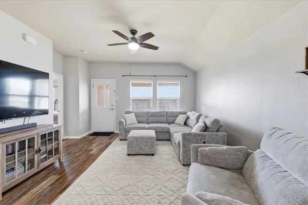 a living room with furniture and a flat screen tv