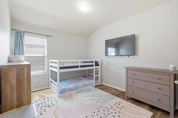 a bedroom with a bed and a television