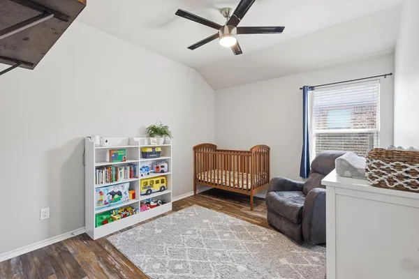 a bedroom with furniture and a book shelf