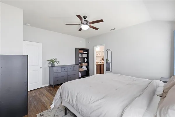 a bedroom with a bed and a dresser