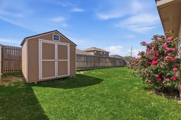 a view of a house with a big yard and potted plants in front of it