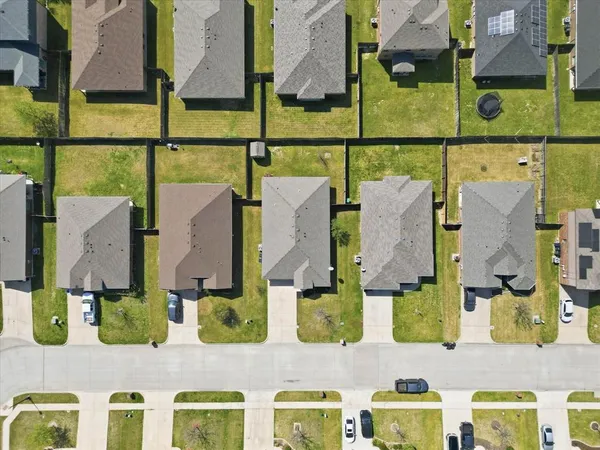 an aerial view of residential houses with outdoor space
