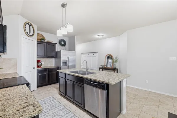 a kitchen with a stove top oven a sink and dishwasher