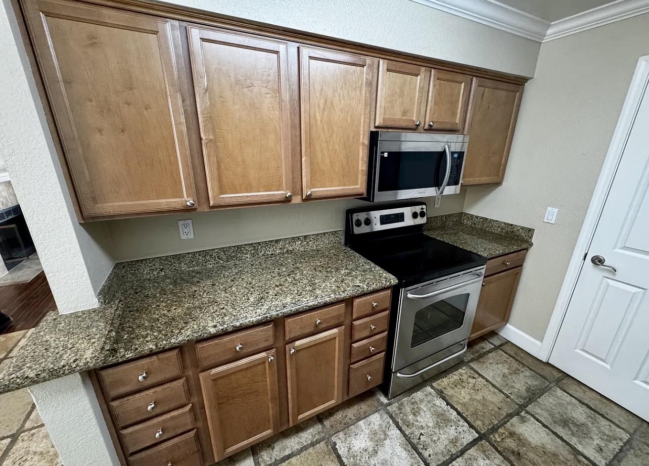 331 Eastridge Drive San Ramon, CA 94582 - Photo 4 of 15 a kitchen with granite countertop a sink and a stove top oven