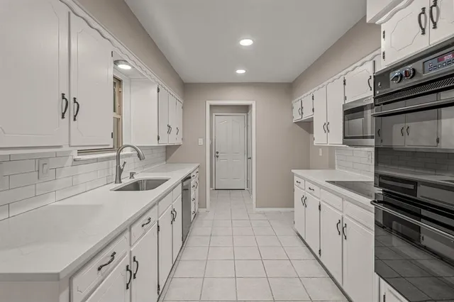 a kitchen with a sink stove and cabinets