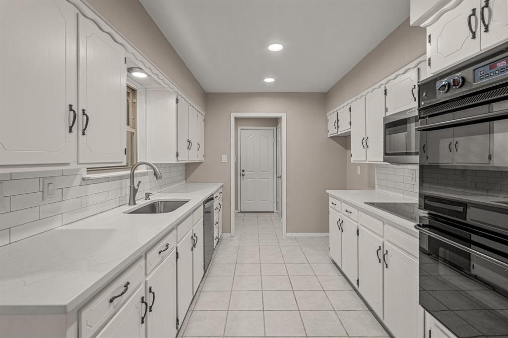 2216 Archer Trail Denton, TX 76209 - Photo 13 of 26 a kitchen with a sink stove and cabinets