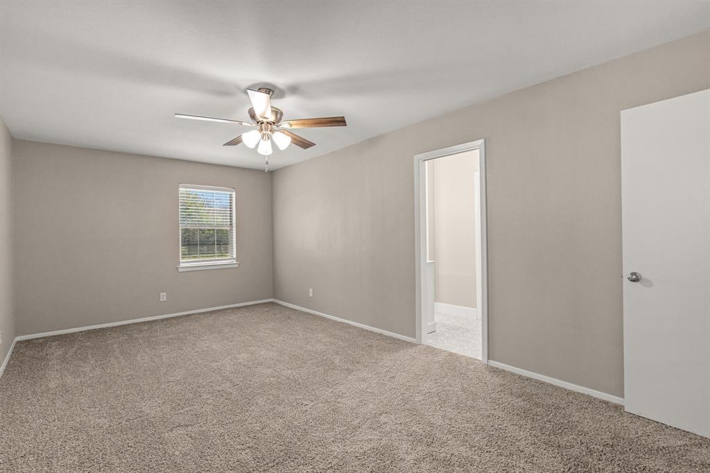 2216 Archer Trail Denton, TX 76209 - Photo 20 of 26 a view of a room with a ceiling fan and a window